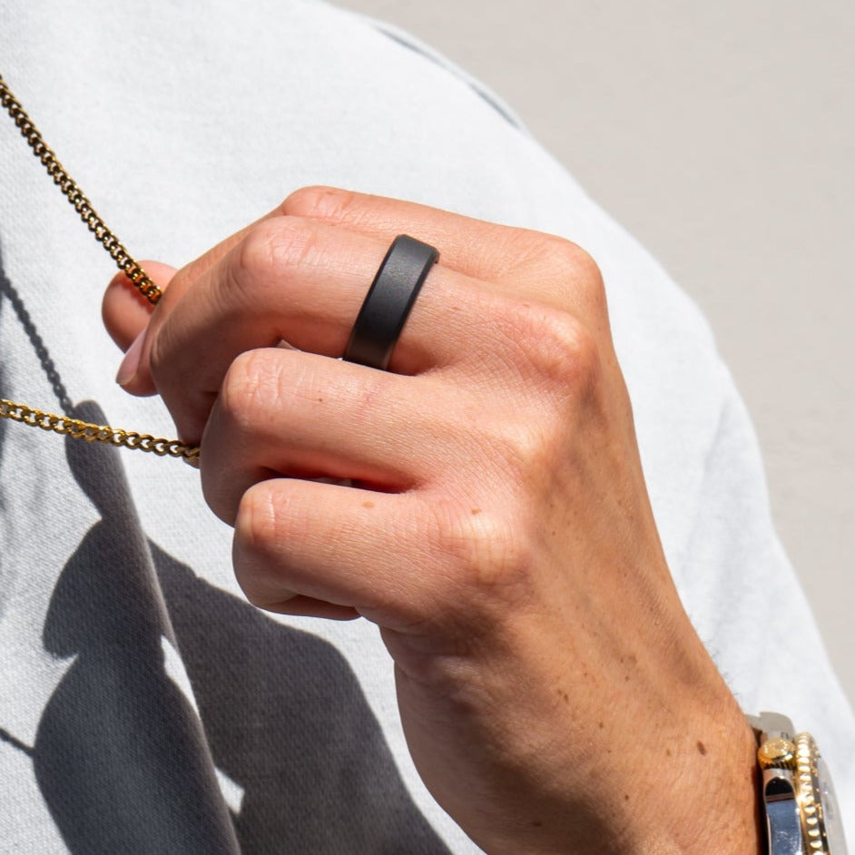 Lifestyle shot #1 of men's hands wearing our Elysium ARES solid black diamond ring | Men’s Black Diamond Rings | Black Diamond Wedding Bands | ElysiumBlack.com