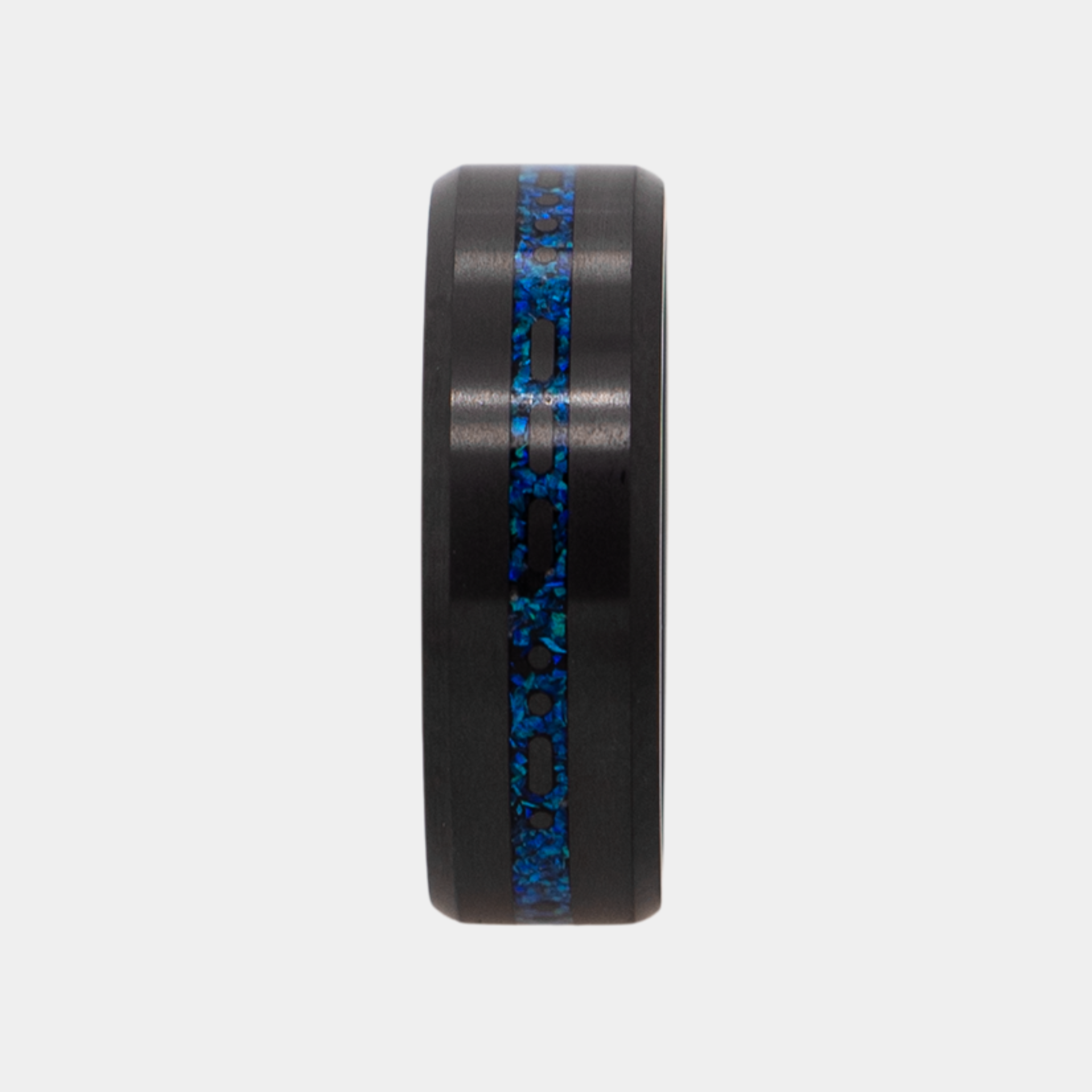 Vertical view of Solid Black Diamond ring with a laser engraved inlay reading "I love you" in morse code, filled with dark blue opal on a grey background