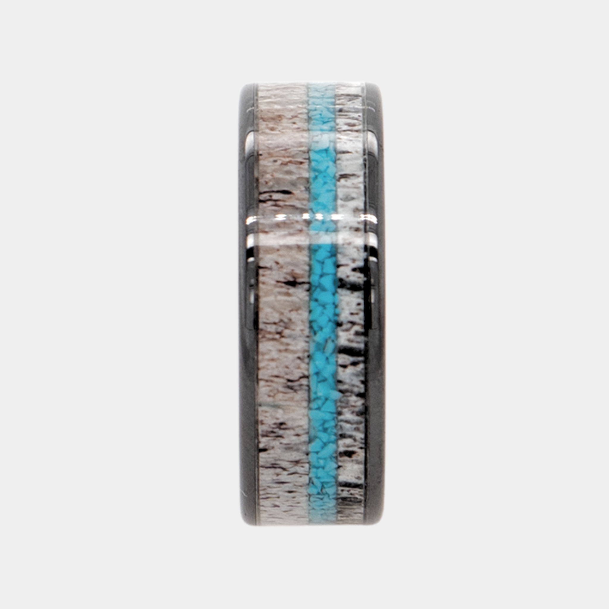 Hermes ring – Polished Black Ceramic with Turquoise and Deer Antler Inlays from the Hustler Collection. Ring standing upright to show profile and thickness.