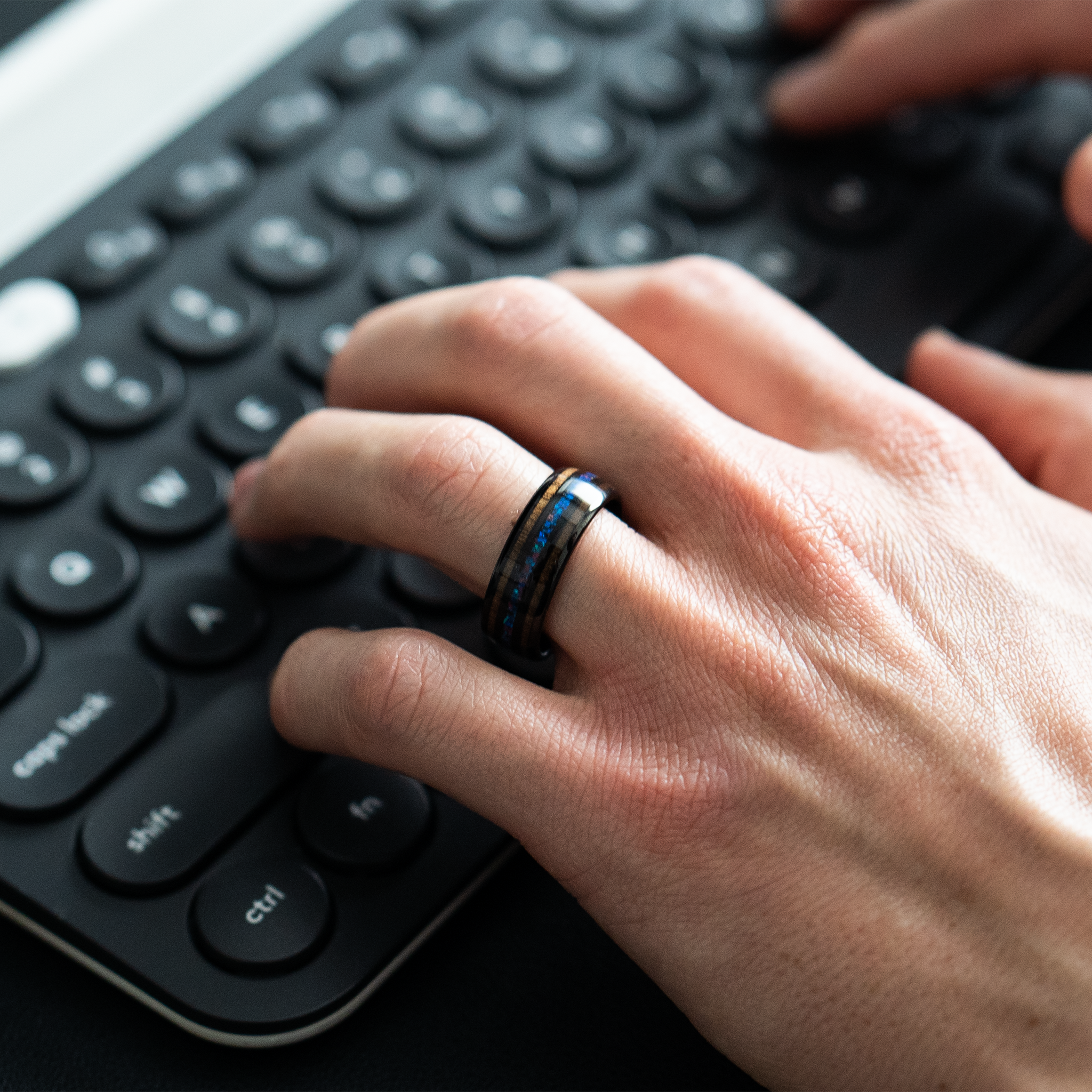 Nereus ring – Black Tungsten featuring Double Koa Wood and Crushed Opal Inlays from the Hustler Collection. Lifestyle Shot - On Hand