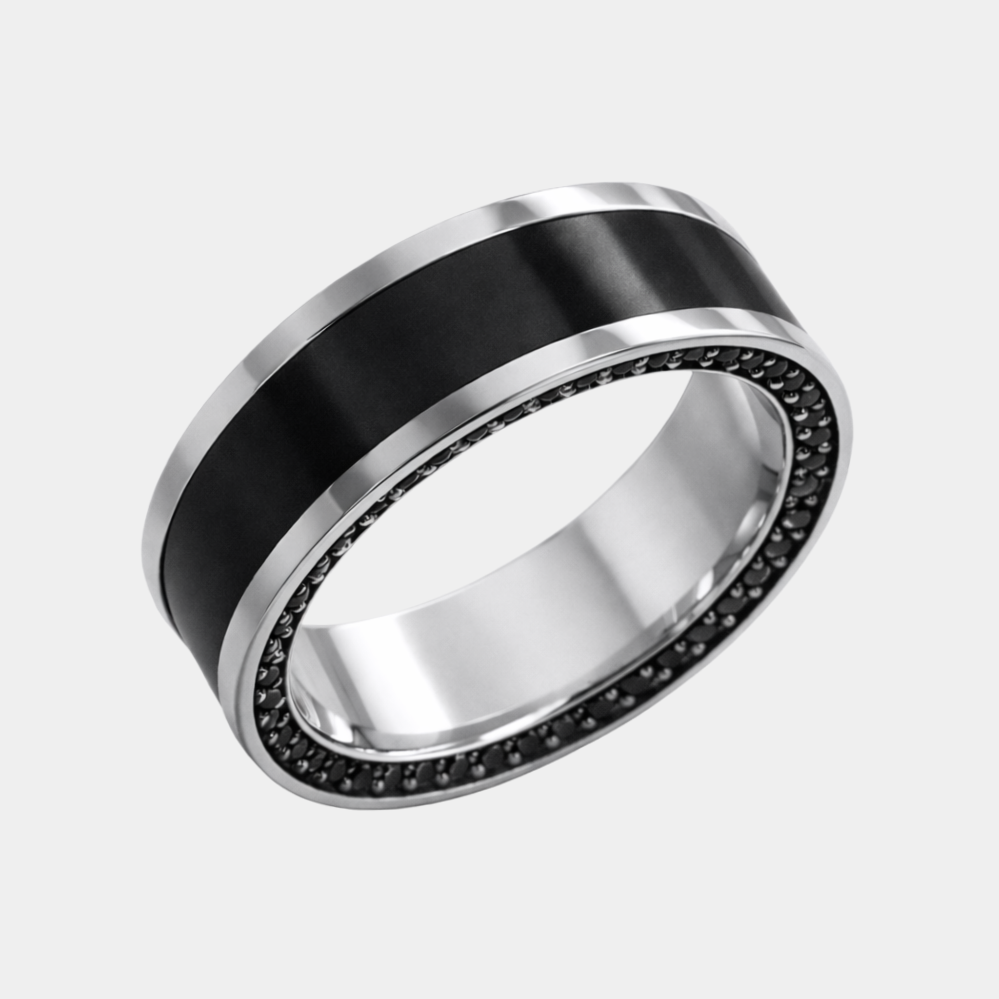 A platinum reverse inlay ring with a solid black diamond inlay and a row of small black stones around the inner edge.