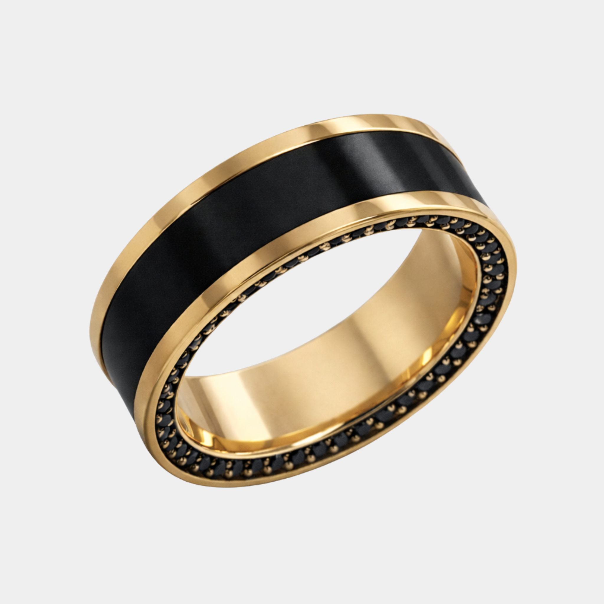 A yellow gold reverse inlay ring with a solid black diamond inlay and a row of small black stones around the inner edge.