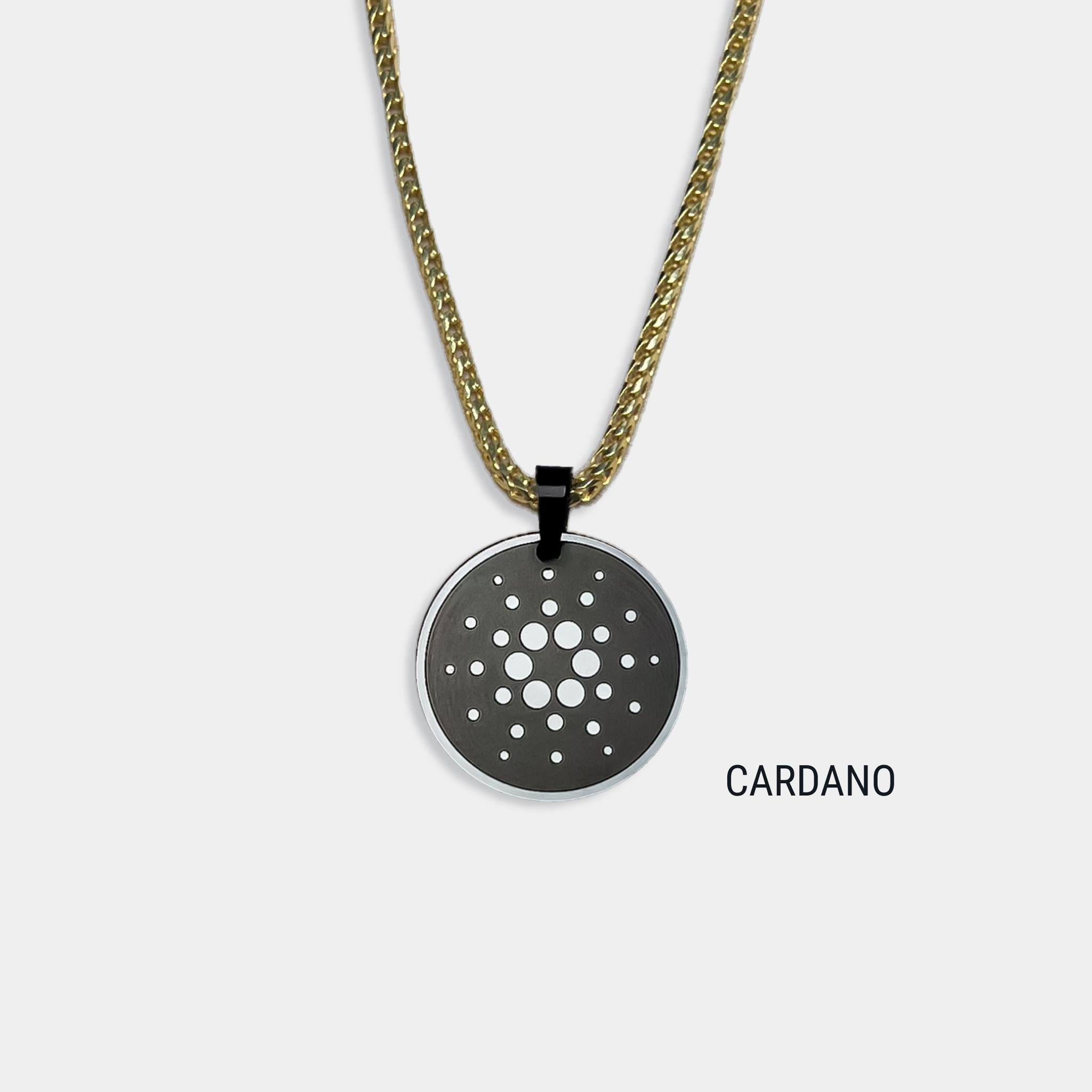 Photo of round solid black diamond pendant with cardano symbol engraved, attached to gold chain