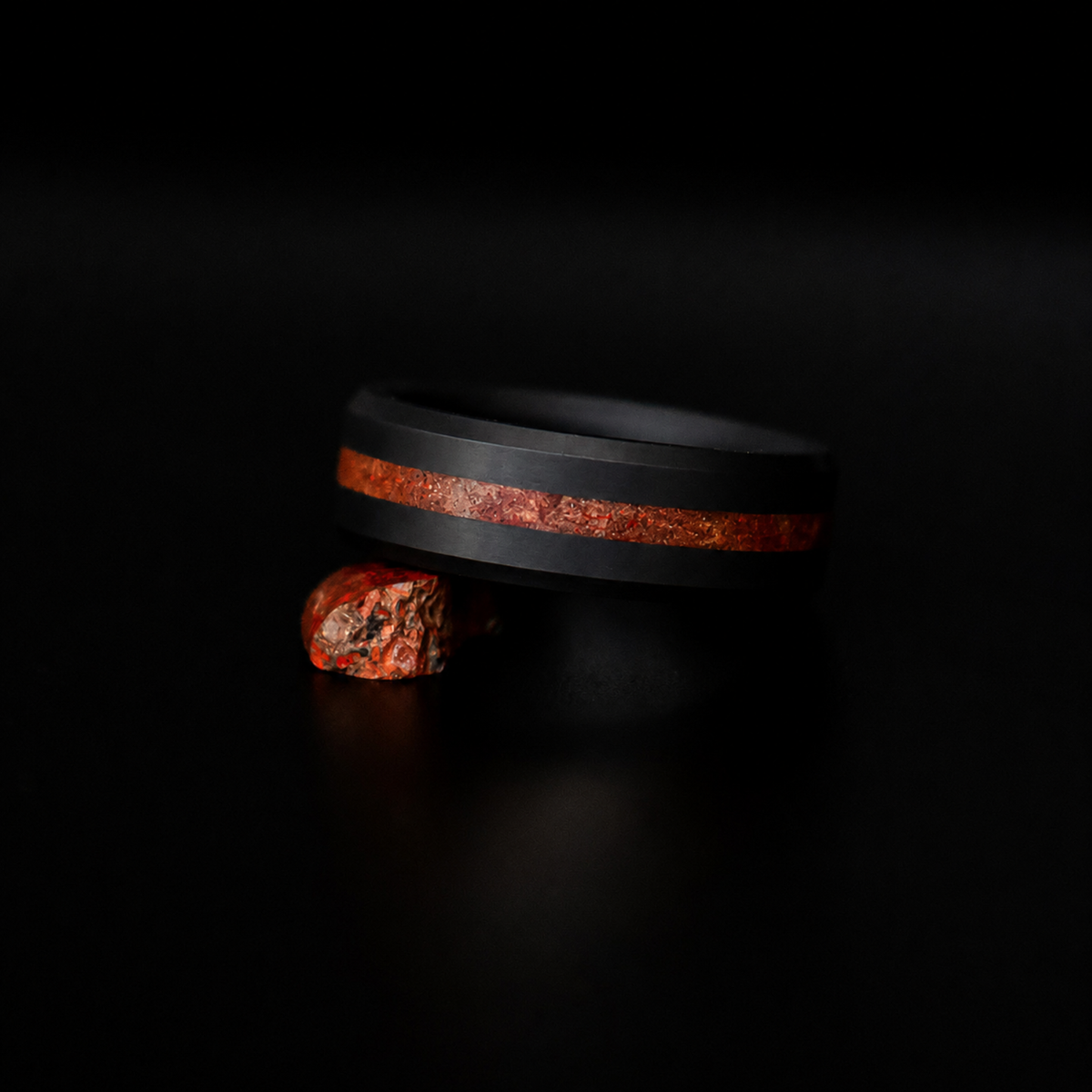 ARES dinosaur bone inlay wedding band in solid black diamond, dark editorial view